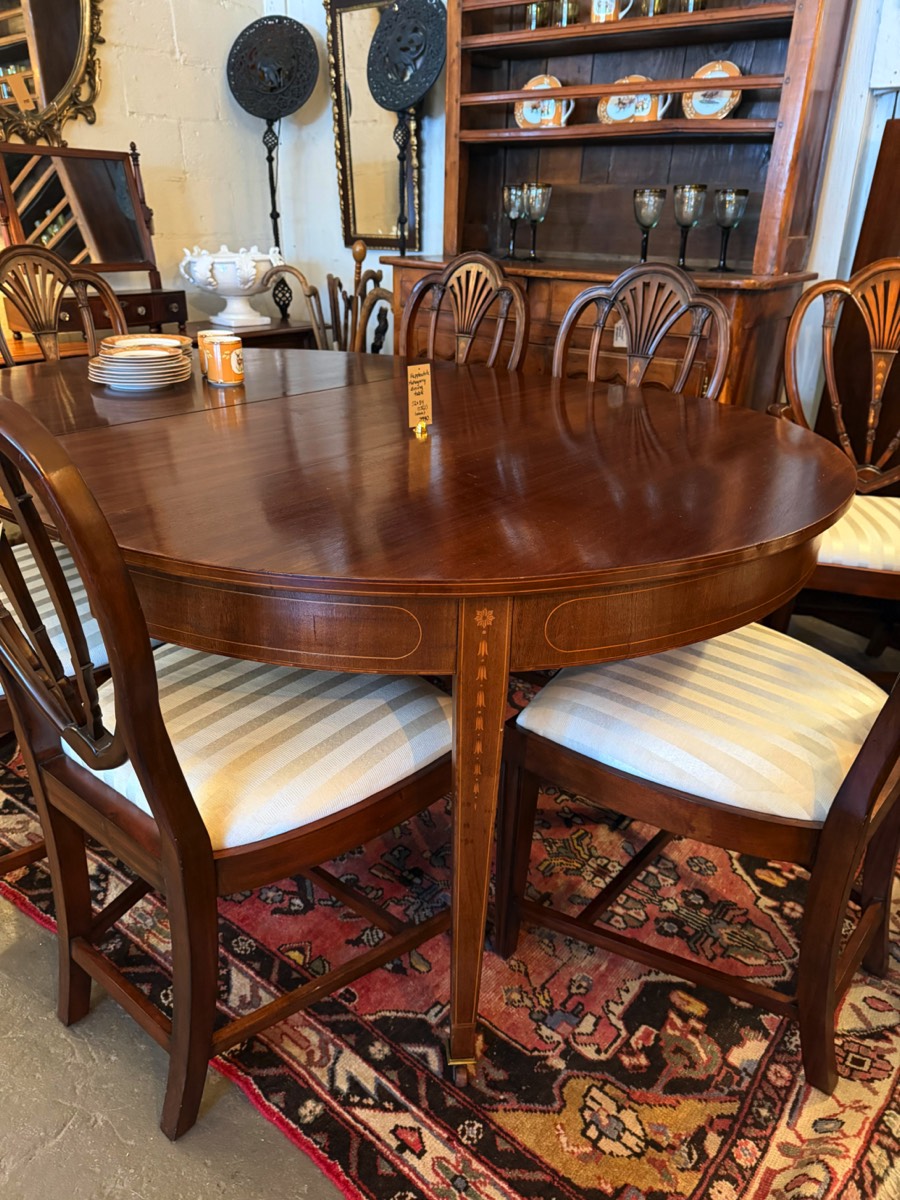 <b>Hepplewhite-Style Mahogany Dining Table</b><br> 2 leaves; seats 8 fully extended<br> approx. 30.5 tall x 53 diam x 88 inches long (extended)<br> circa 20th cen. 